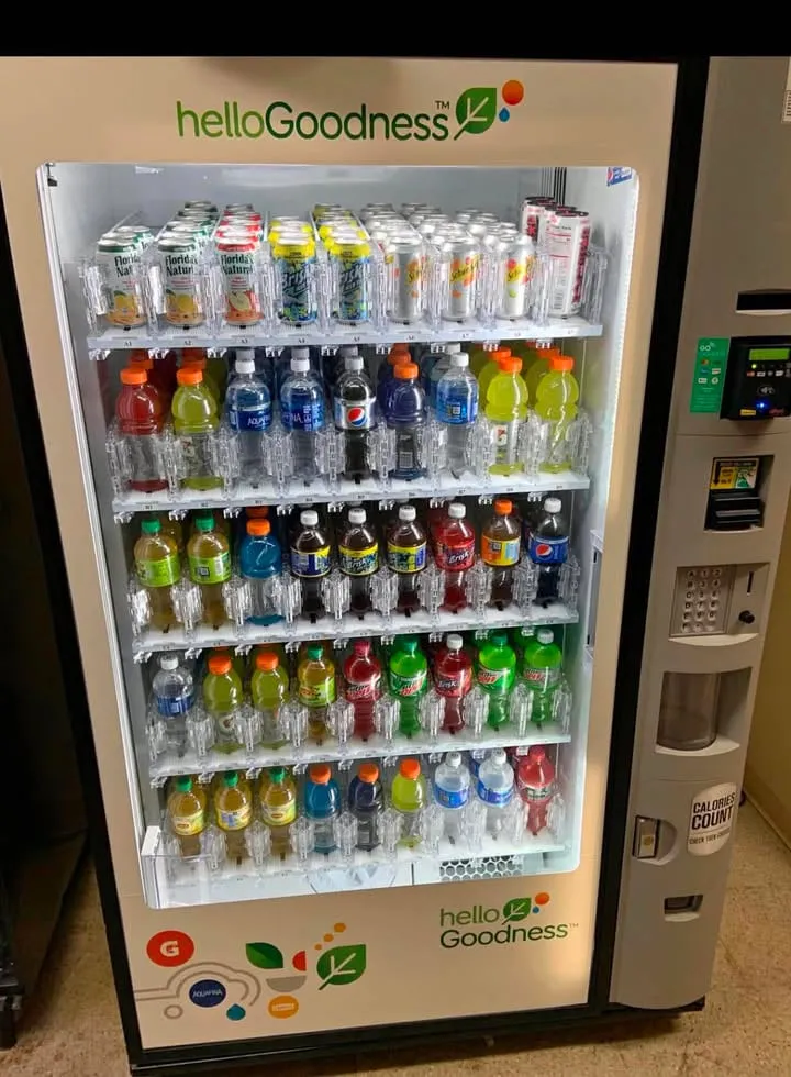 Glass-front beverage vending machine filled with bottled water, juices, sparkling water and low-sugar drinks for a healthy workplace breakroom